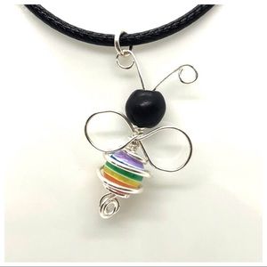 Bee Supportive Charm on a Black Cord.